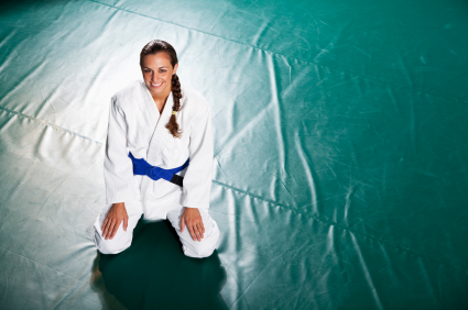 Young woman practicing Brazilian jiu-jitsu is a martial art, self defense system and combat sport.